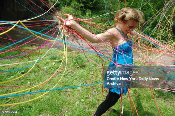 Jasmine Zimmerman dances in the tangle of the string created by herself and Danish visual artist Karoline H. Larsen at McCarren Park in Brooklyn. The...