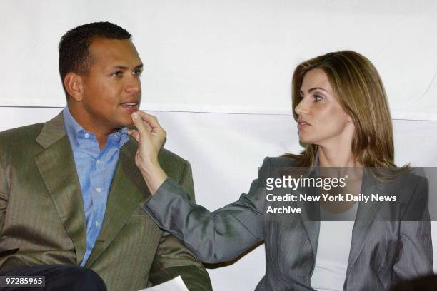 Cynthia Rodriguez wipes the chin of her husband, New York Yankees' Alex Rodriguez, during a press conference announcing his $200,000 donation to a...
