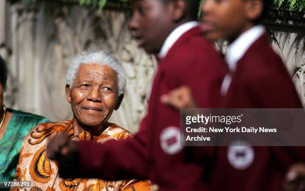 Nelson Mandela smiles as youngsters from the Boys Choir of Harlem perform for him during a visit to Riverside Church on Manhattan's upper West Side....