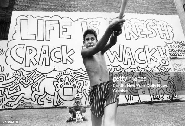 Nelson Pena, ten, takes a whack at a ball during a pickup game in a school yard on East Houston Street.