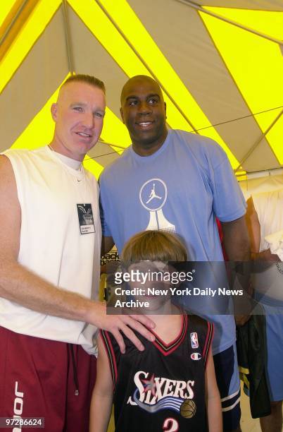 Former NBA stars Chris Mullin and Earvin Johnson tower over Mullen's son, Chris Jr., at the first annual Celebrity Hoops benefit in Bridgehampton,...