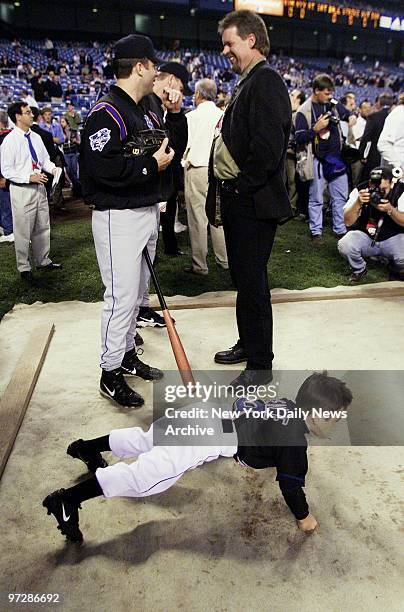 Six-year-old Garrett Zeile, son of New York Mets' Todd Zeile , does pushups before Game 1 of the World Series between the New York Yankees and the...