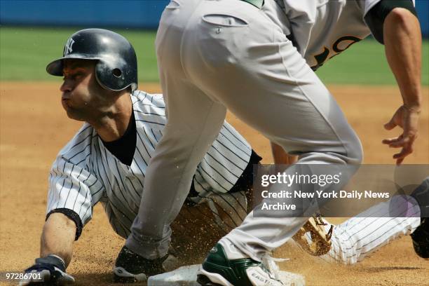 The New York Yankees' Derek Jeter is safe at third on a steal in a game against the Oakland A's at Yankee Stadium. The Yanks won, 5-1.