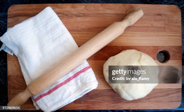 dough with rolling pin on wooden table - rolling pin stock pictures, royalty-free photos & images