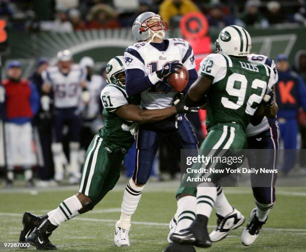 New England Patriots' quarterback Tom Brady is sacked by New York Jets' Jonathan Vilma as the Jets' Shaun Ellis looks on in the first quarter of game...