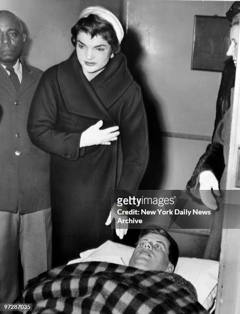 Sen. John F. Kennedy with his wife, Jackie, leave the Hospital for Special Surgery in New York City after a spinal operation related to World War II...