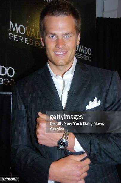 New England Patriots' quarterback Tom Brady shows off his Movado Sports Watch as he launches the Movado Series 800 Sport Watch Collection at their...