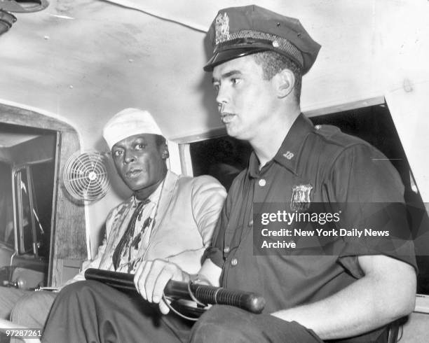 Jazzman Miles Davis rides in an ambulance with Patrolman Gerald Kilduff to St. Clare's Hospital, where Davis was given ten stitches in his scalp....