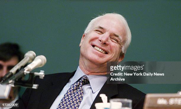 Sen. John McCain, back on the job as chairman of the Senate Commerce Committee, laughs at remarks of Sen. Ernest Hollings , who apologized for the...