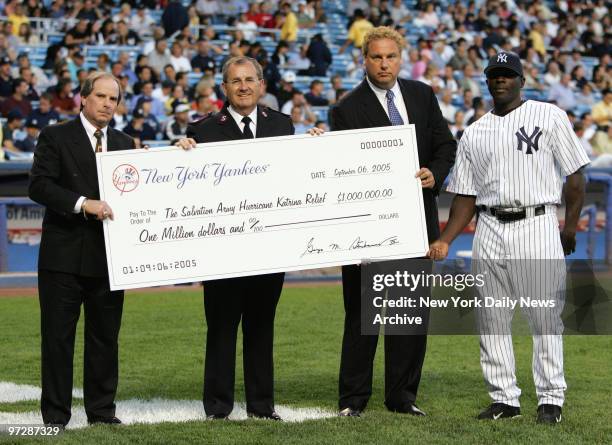 Major Guy Klemanski, General Secretary of the Salvation Army of Greater New York , accepts an oversized check for $1 000 for the victims of Hurricane...