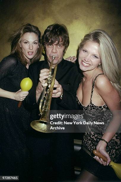 Buster Poindexter on the trumpet with Playmates Danielle Folta and Victoria Zdrok celebrating new release of "Buster's Spanish Rocketship" at El...