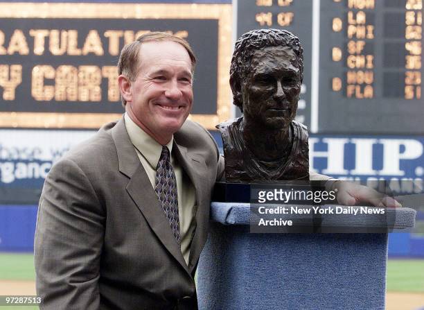 Former New York Mets' catcher Gary Carter gets together with a bust of himself at Shea Stadium, where he was inducted into the Mets Hall of Fame in a...