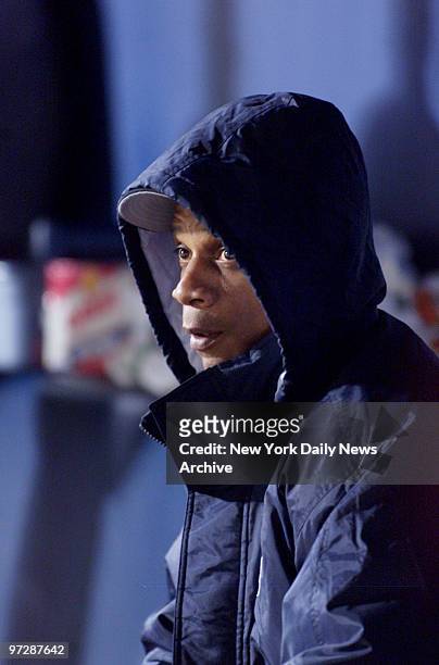 New York Yankees' Darryl Strawberry tries to stay warm in the dugout during Game 2 of the World Series between the Yankees and Atlanta Braves at...