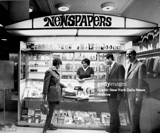 Jeanne Hechtman buys a copy of the Daily News at a prototype of modern newsstand at Gimbel's Wonderful World of New York Exhibit, 32nd Street and...