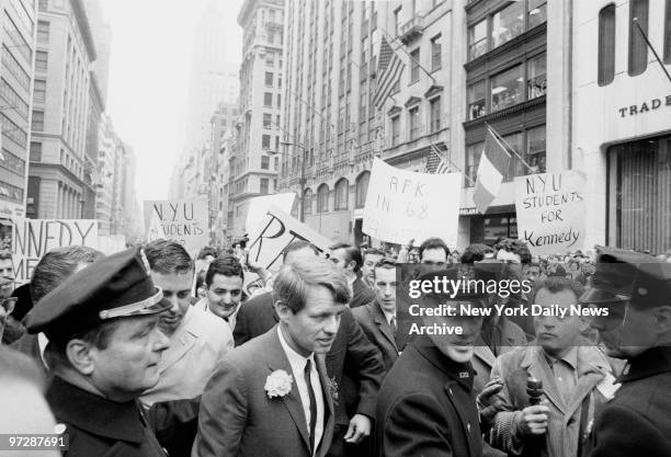 Sen. Robert F. Kennedy is flanked by police as he tries to make his way through a crowd of supporters to the St. Patrick's Day Parade.