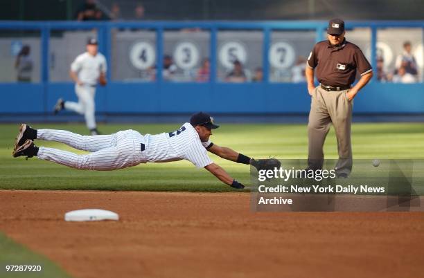 New York Yankees' Derek Jeter dives but misses a ground ball hit by Oakland Athletics' Olmedo Saenz in the sixth inning of game at Yankee Stadium....