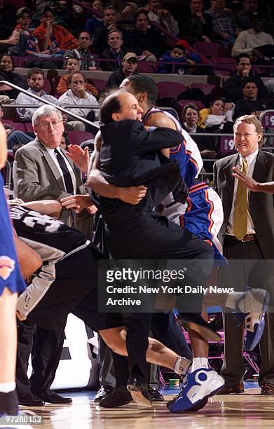 Jeff Van Gundy and Marcus Camby collide as the New York Knicks' coach comes between his angry player and the San Antonio Spurs' Danny Ferry in the...
