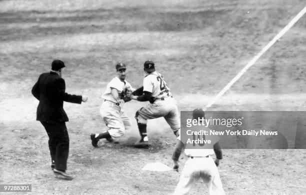 Cal Abrams, Dodger left fielder, is tagged out at the plate by Phillies' catcher Stan Lopata in ninth inning of Philadephia-Brooklyn game at Ebbetts...
