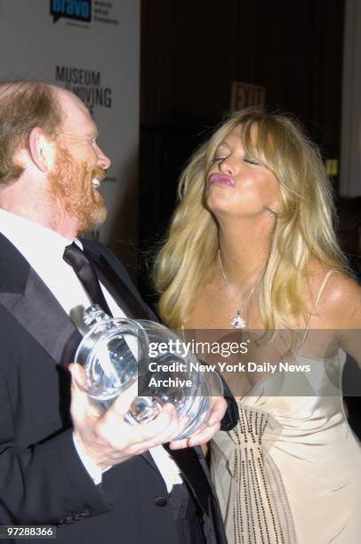 Goldie Hawn puckers-up to honoree Ron Howard at the Waldorf-Astoria hotel during the Museum of the Moving Image's 21st annual black-tie Salute.