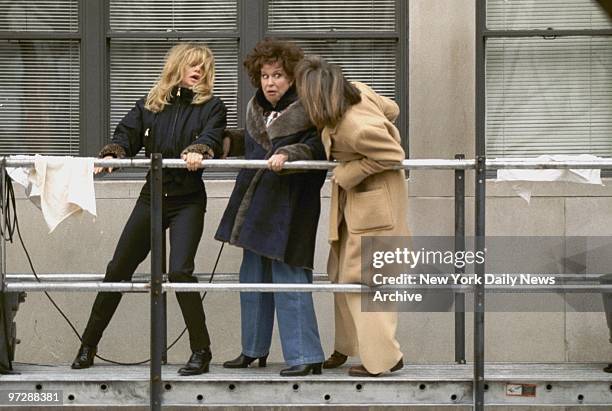 Goldie Hawn, Bette Midler and Diane Keaton hang onto a building scaffold as they film the movie "First Wives Club" at Fifth Ave. And 87th St.,