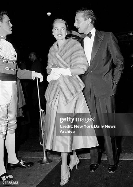 Grace Kelly and Oleg Cassini outside the Roxy Theater for a movie premiere.