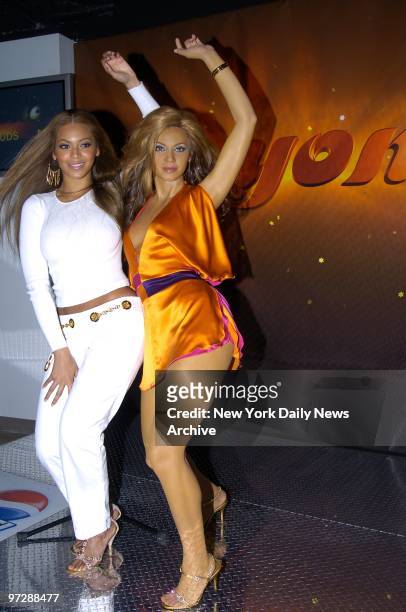 The real Beyonce Knowles lines up her curves with her waxen image, a new arrival at Madame Tussaud's in Times Square.