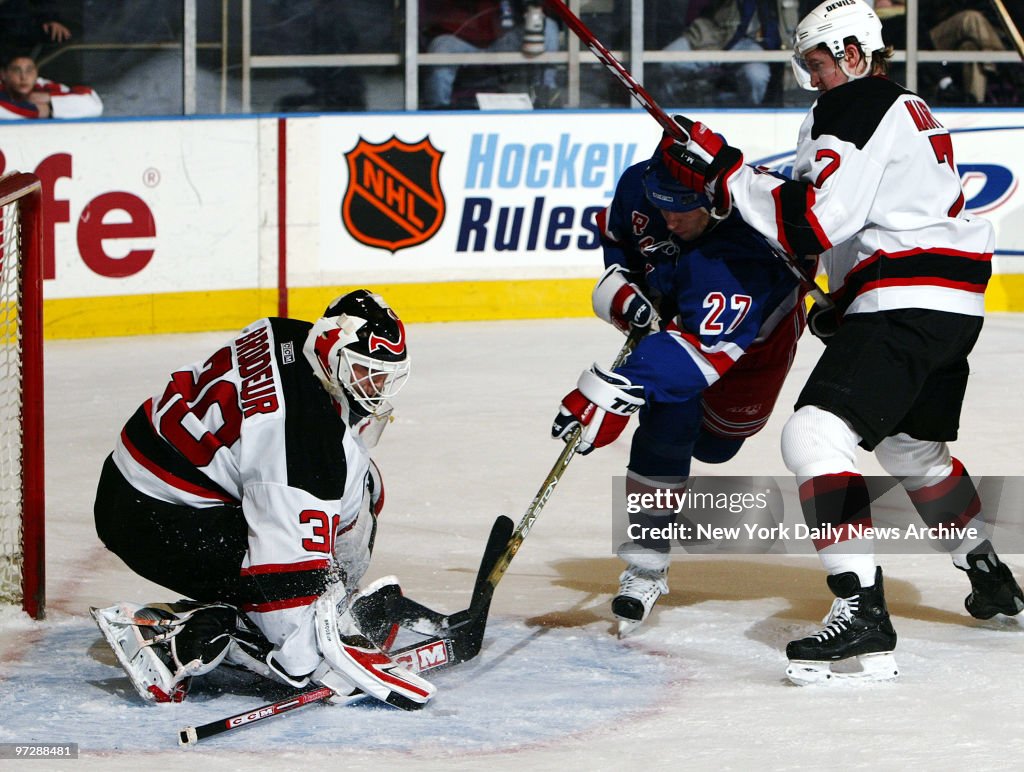 New Jersey Devils' goalie Martin Brodeur stuffs a shot by th