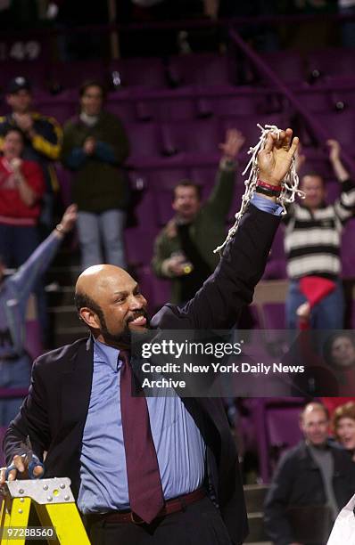 The Red Storm's head coach Mike Jarvis holds up the net in triumph after St. John's beat the Connecticut Huskies at Madison Square Garden, 80-70, to...