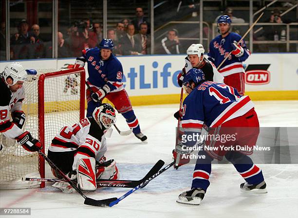 New Jersey Devils' goaltender Martin Brodeur makes a save against the New York Rangers' Petr Sykora during game three of the first round NHL...