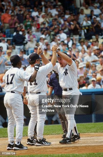 Former New York Yankee Wade Boggs celebrates his three-run homer with Yankee greats Mickey Rivers and Rick Cerone during 56th annual Old Timers' Day...
