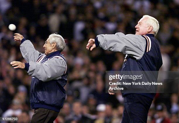 Former New York Yankees and Hall of Famers Phil Rizzuto and Whitey Ford throw out the ceremonial first pitch of Game 2 of the World Series between...