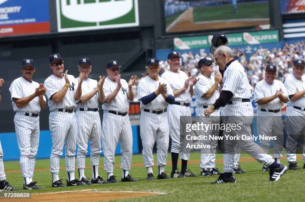 Former New York Yankees' catcher and manager Yogi Berra - a baseball Hall of Famer - tips his cap as he's introduced during 59th annual Old-Timers'...