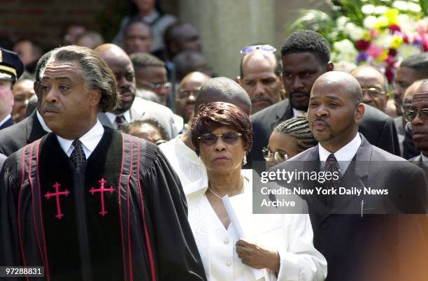 The Rev. Al Sharpton joins with Thelma Davis, the mother of slain City Councilman James Davis, and his brother, Geoffrey , outside the Elim...