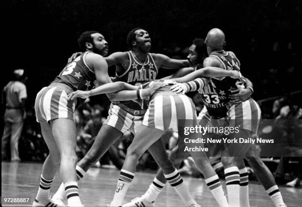 Meadowlark Lemon and his teammates huddle during game to plan more deviltry.,