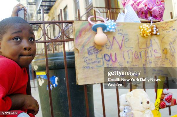 Shamel Youmans a neighbor, stands beside a makeshift memorial on Madison St. In Bedford-Stuyvesant, Brooklyn, where 3-year-old Marcus Lee lived. The...