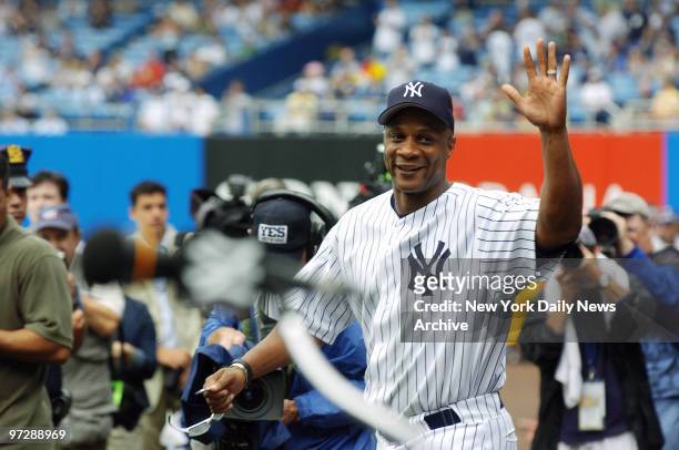 Former New York Yankees' outfielder Darryl Strawberry waves as he's introduced during 60th annual Old-Timer's Day ceremonies at Yankee Stadium. He...
