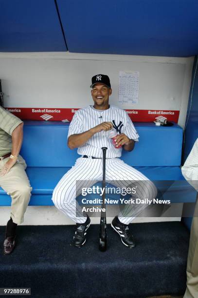 Former New York Yankees' outfielder David Justice grins as he sips a sports drink in the dugout during 59th annual Old-Timers' Day festivities at...