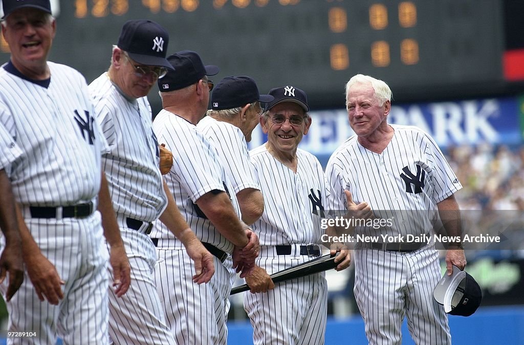 Former New York Yankees' pitcher Whitey Ford (right) jokes w