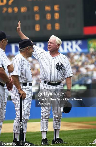 Former New York Yankees' pitcher Whitey Ford waves to the crowd while former Yanks' catcher Yogi Berra grins during introductions at annual Old...