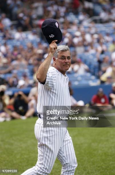 Former New York Yankees' shortstop and manager Bucky Dent tips his hat on the field during 57th annual Old-Timers' Day festivities at Yankee Stadium....