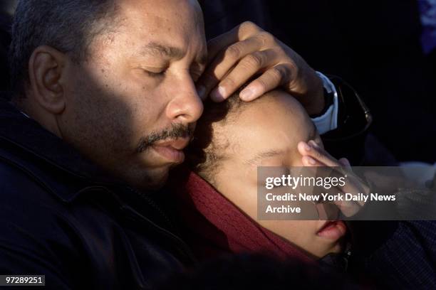 Man comforts a child during a prayer service for victims of the crash of American Airlines Flight 587 at Jacob Riis Park in the Rockaways, Queens....