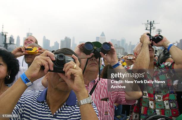 Cameras and binoculars are in fashion as crowd follows progress of the tall ships plying the Hudson River during OpSail 2000.
