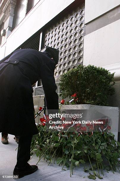 Man leaves a red rose in remembrance of victims of the infamous Triangle Shirtwaist Company fire during a memorial service held by the Hebrew Union...