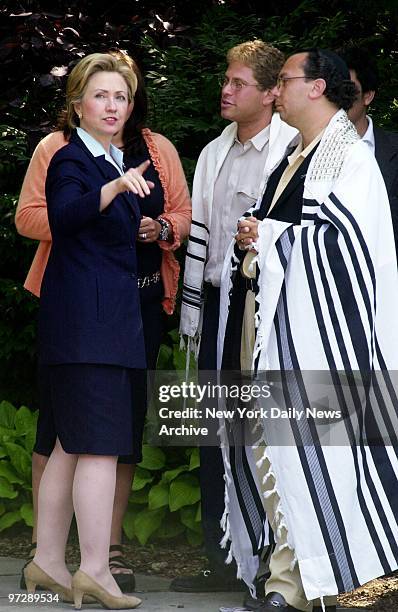 Senatorial hopeful Hillary Rodham Clinton speaks with Rabbi Marc Schneier and another temple member after attending services at Hampton Synagogue in...