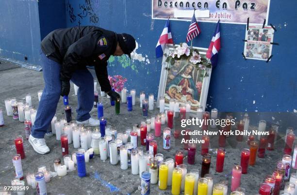 Man lights memorial candles at 163 St. And St. Nicholas Ave. In Washington Heights for those lost during the crash of American Airlines Flight 587...