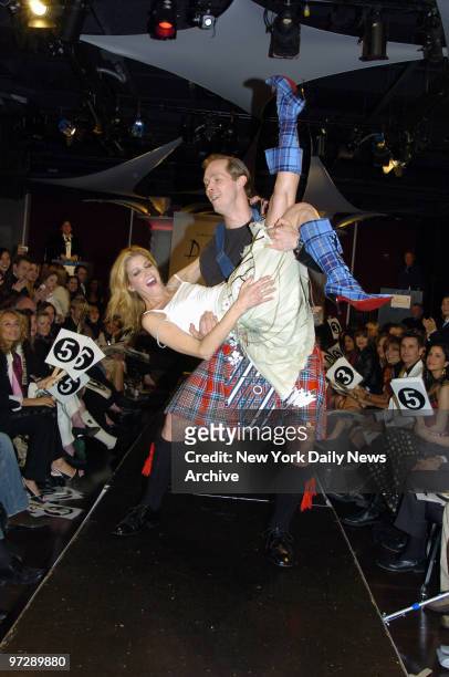Candace Bushnell is carried down the runway by husband Charles Askegard during a fashion show at the Dressed to Kilt gala, an evening of Scottish...