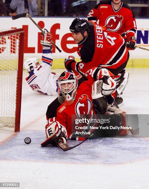 New Jersey Devils' Scott Stevens watches the puck gets by goalie Martin Brodeur for a power play goal in a game against the New York Rangers at...