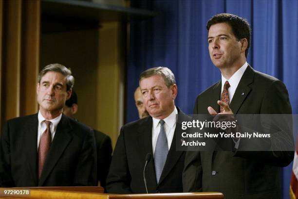 Manhattan U.S. Attorney James Comey speaks at a Washington news conference as FBI Director Robert Mueller and Attorney General John Ashcroft look on...