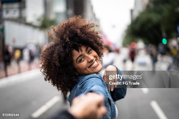 point of view of girlfriend holding hands of boyfriend - paulista avenue sao paulo stock pictures, royalty-free photos & images