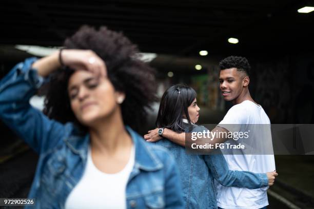 disloyal man with his girlfriend looking at another girl - meme stock pictures, royalty-free photos & images